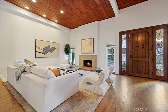 a living room with fireplace furniture and a wooden floor