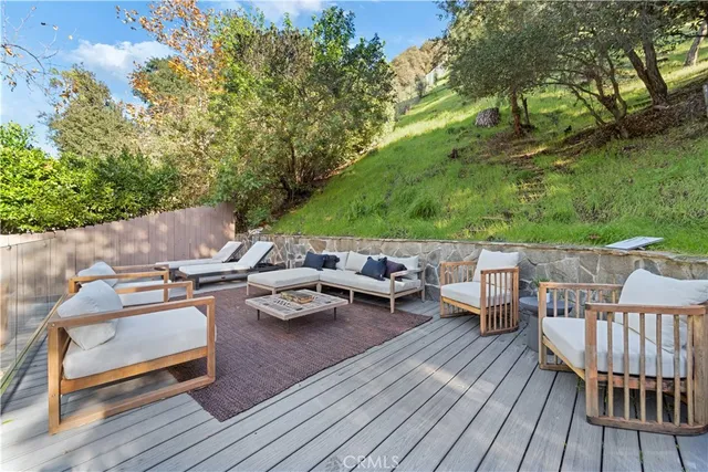 a view of a dinning table and chairs on the roof deck