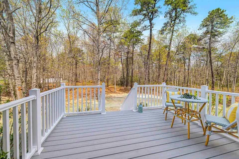 a view of a deck with chairs and table on the wooden floor