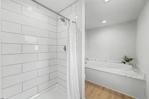 a bathroom with a bathtub and a shower