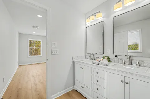 a bathroom with a double vanity sink and a mirror