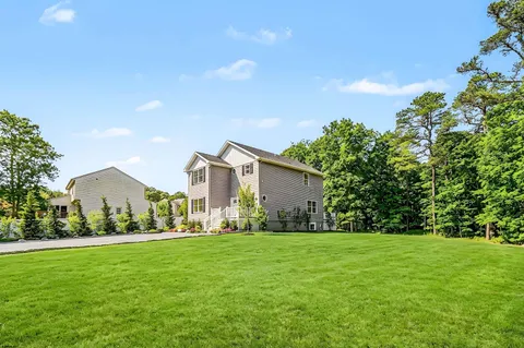 a front view of house with yard and green space