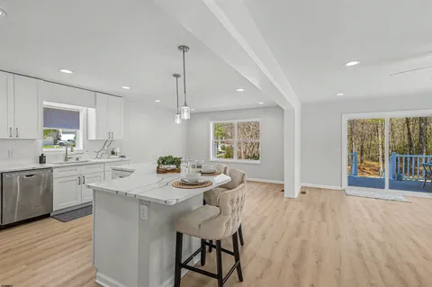 a kitchen with a sink a center island cabinets and wooden floor