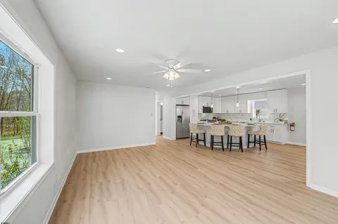 a view of a dining room with furniture and a window