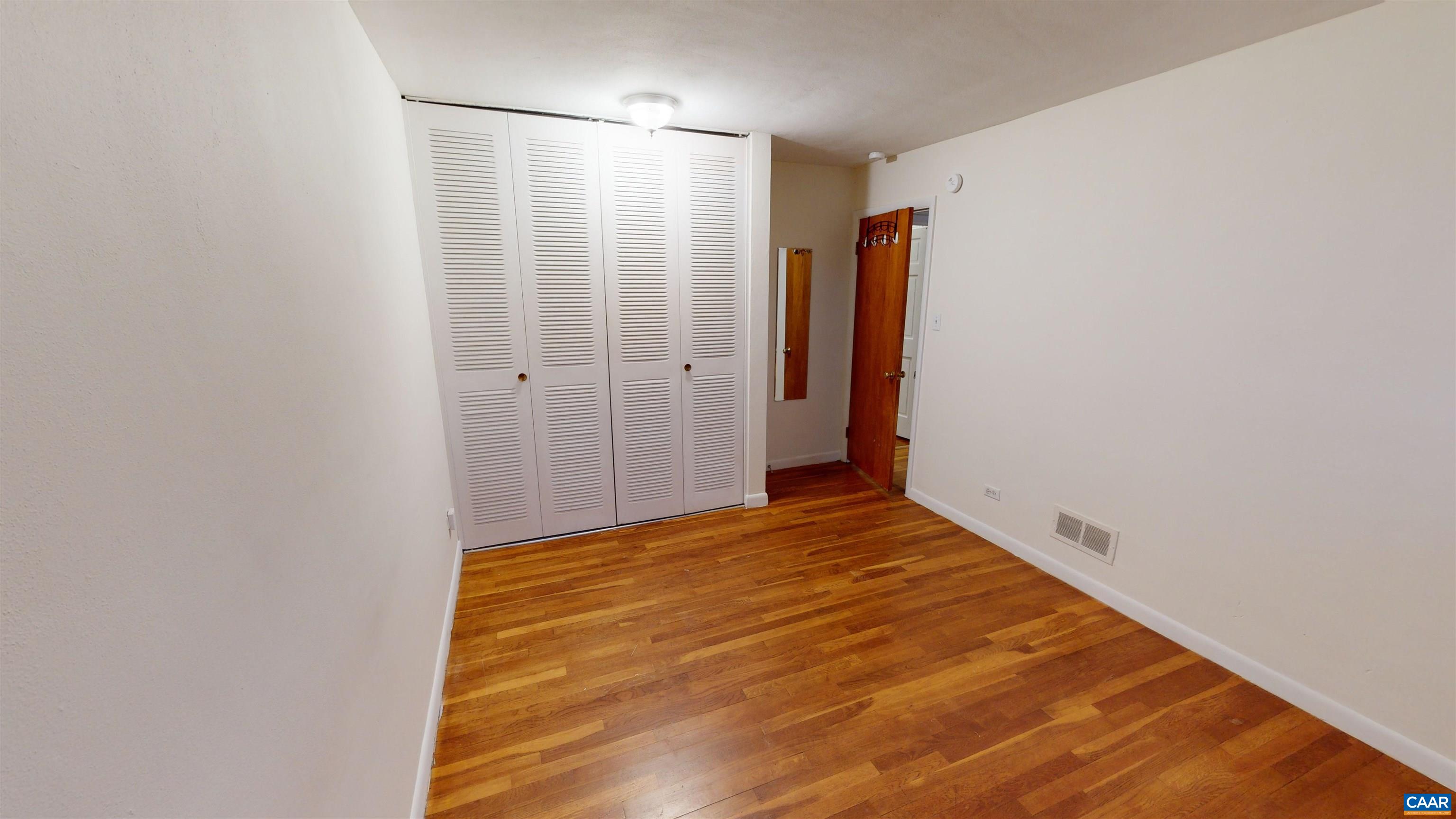 130 Apple Tree Road, Unit A Charlottesville, VA 22903 - Photo 5 of 16 a view of a room with wooden floor and brick wall