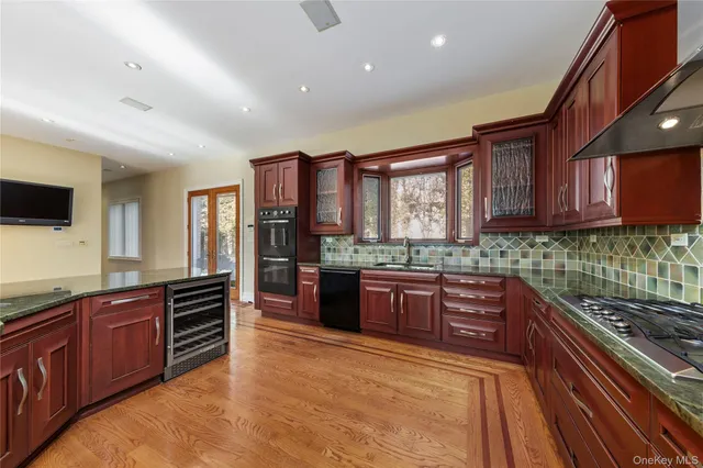 a spacious bedroom with a large bed and a wooden floor