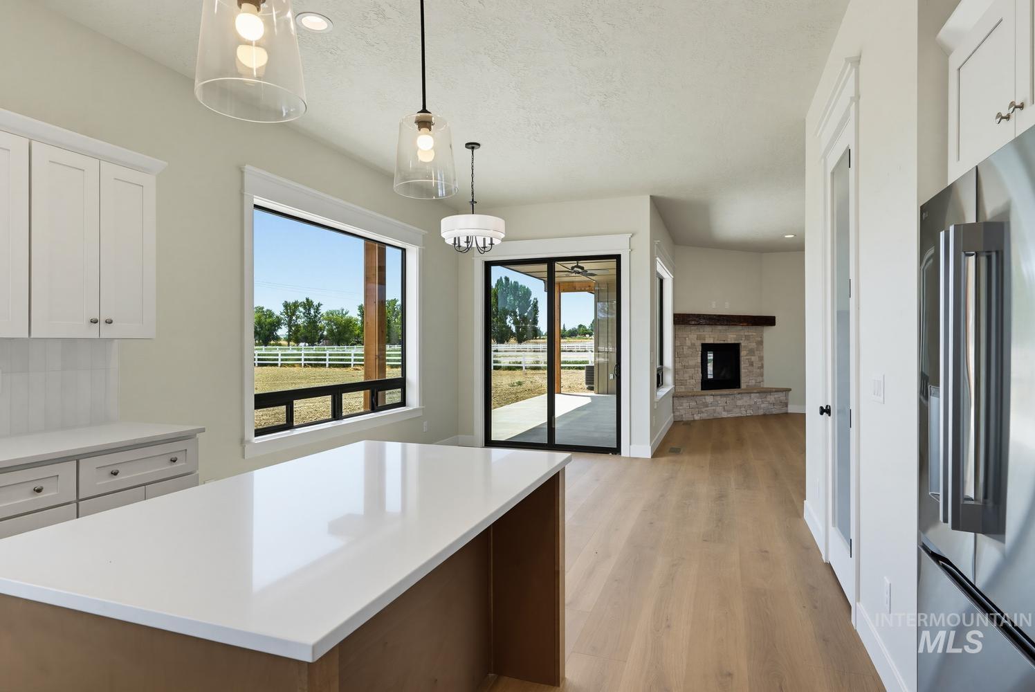 5054 Heritage Drive Marsing, ID 83639 - Photo 4 of 38 Kitchen island with a white countertop and pendant lighting