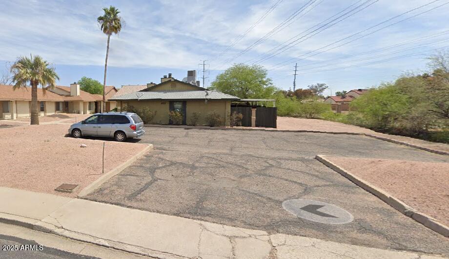 463 North 64th Place, Unit 1 Mesa, AZ 85205 - Photo 1 of 19 a front view of a house with a yard and garage