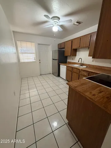a kitchen with stainless steel appliances a refrigerator sink and cabinets