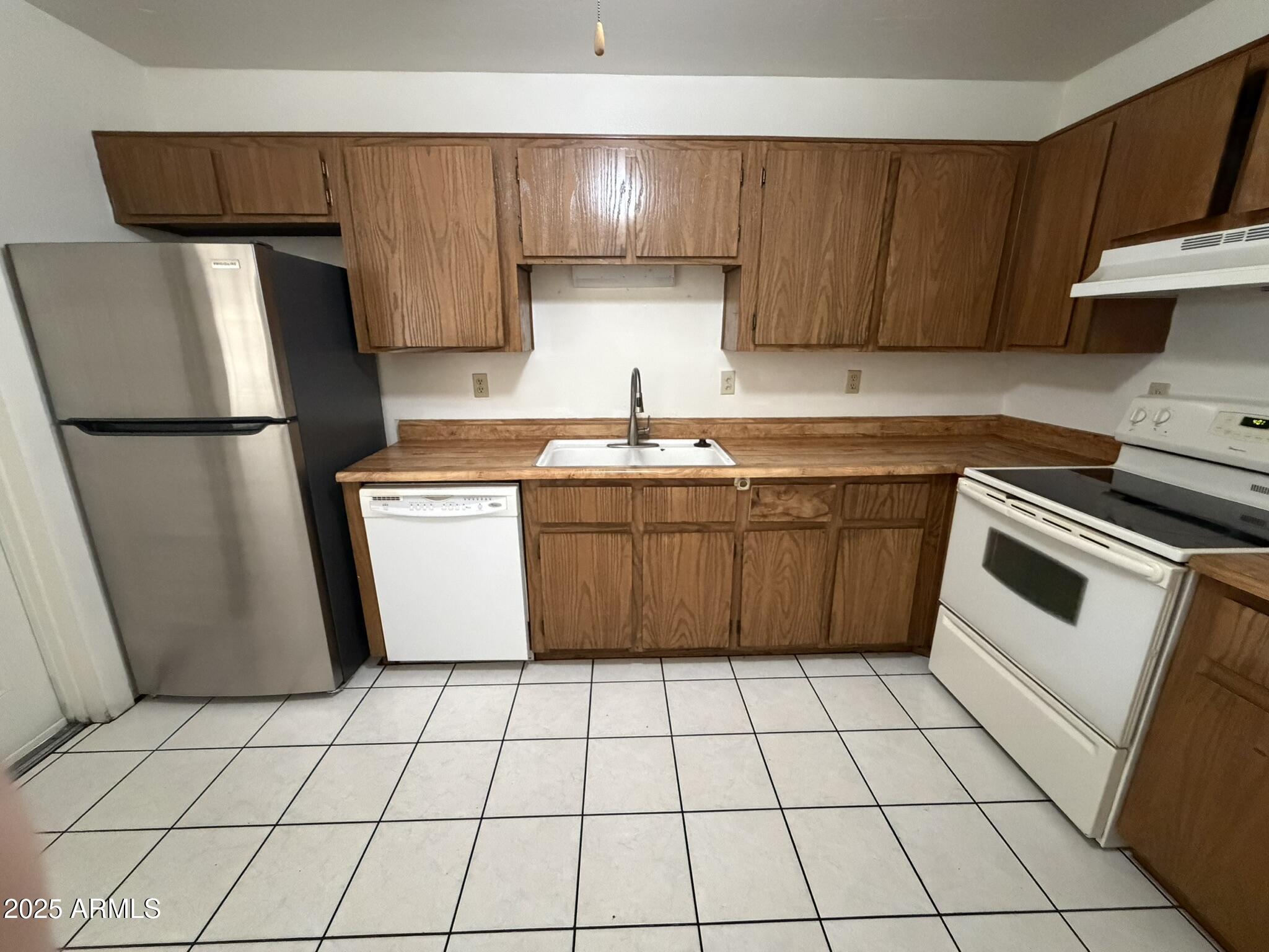 463 North 64th Place, Unit 1 Mesa, AZ 85205 - Photo 12 of 19 a kitchen with stainless steel appliances a refrigerator sink and cabinets