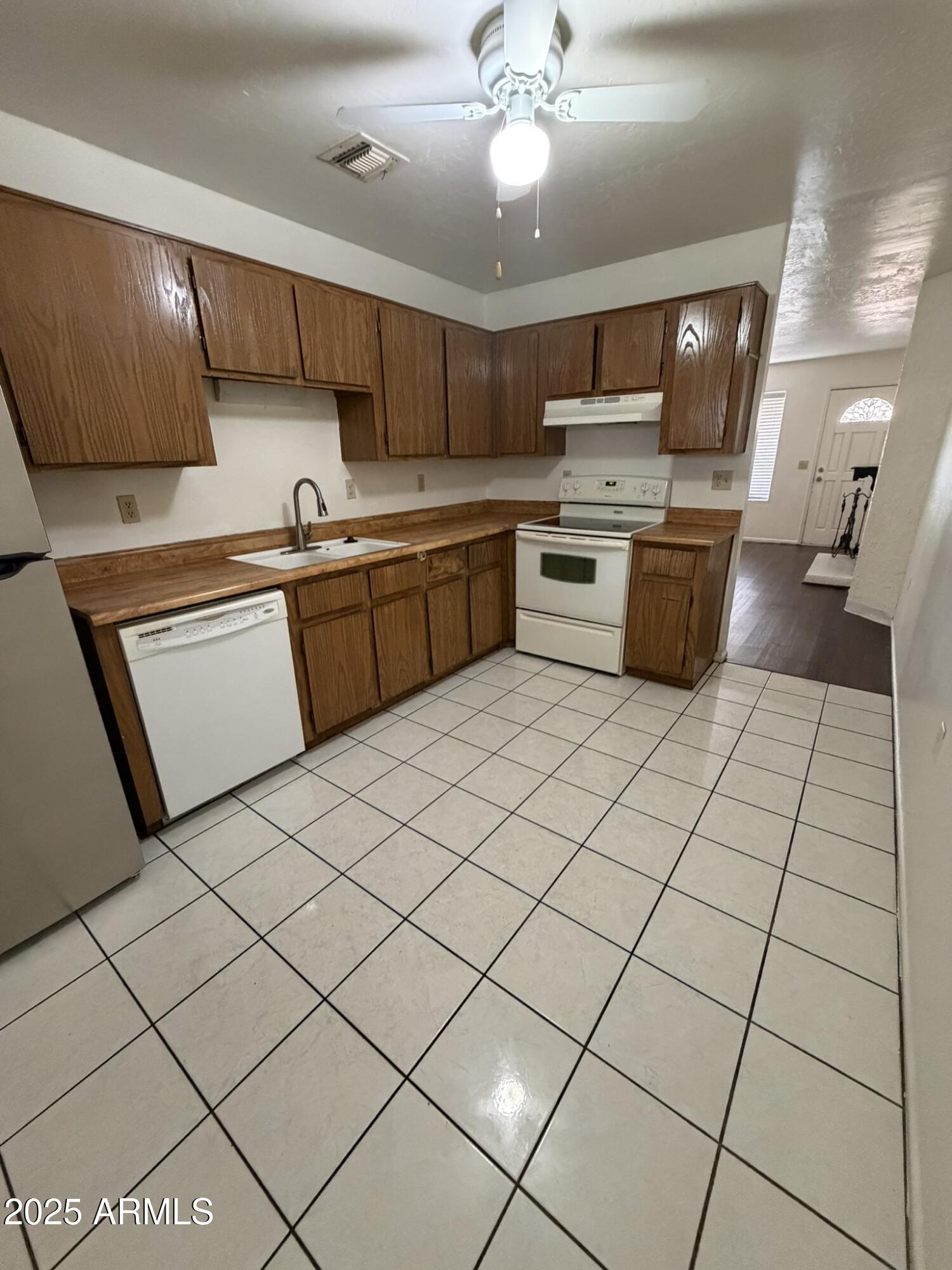 463 North 64th Place, Unit 1 Mesa, AZ 85205 - Photo 13 of 19 a kitchen with stainless steel appliances a sink and a stove top oven