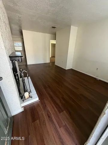 a view of a room with wooden floor