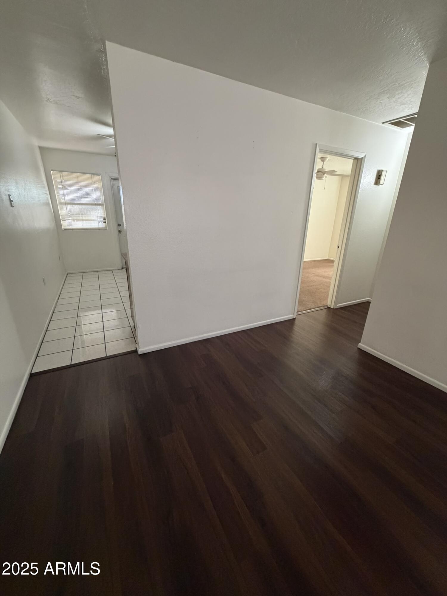 463 North 64th Place, Unit 1 Mesa, AZ 85205 - Photo 5 of 19 an empty room with wooden floor and windows