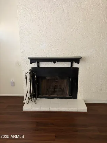 a living room with a fireplace and wooden floor