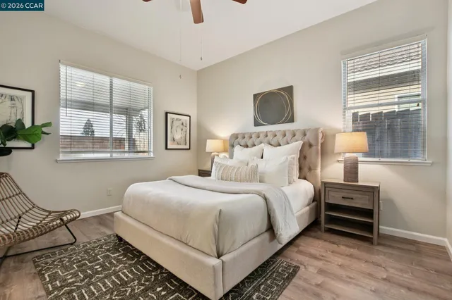 a bedroom with a bed lamp and window
