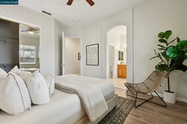 a en suite bathroom with a granite countertop sink and a mirror