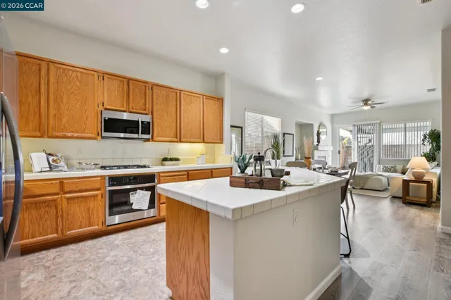 a kitchen with stainless steel appliances granite countertop a sink stove and cabinets