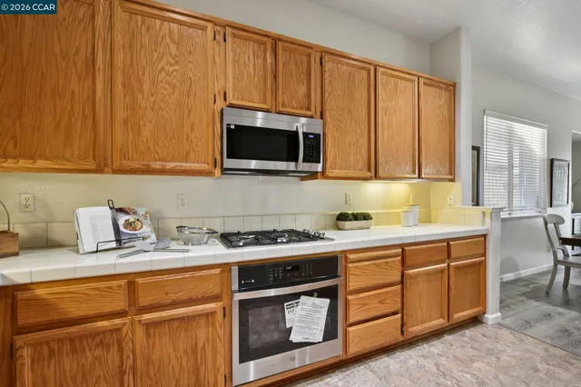 a kitchen with stainless steel appliances granite countertop a sink stove and microwave