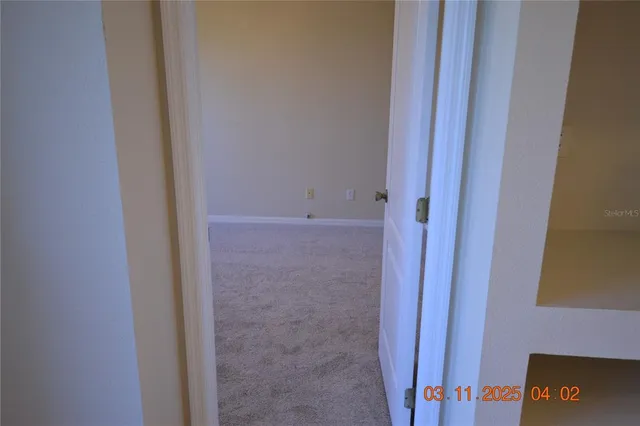 a view of a room with a fan and a window