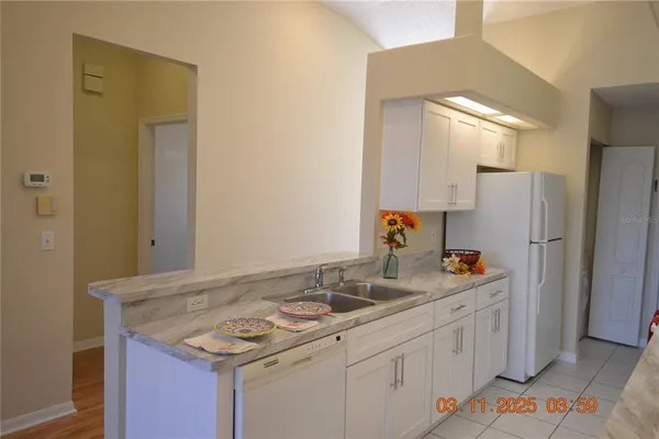 a kitchen with a sink stove and refrigerator