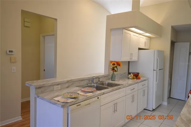 a kitchen with a sink stove and refrigerator