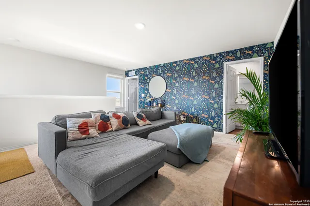 a living room with furniture and a large window