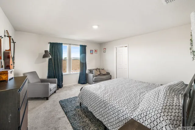 a bedroom with a large bed and a couch