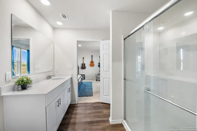 a bathroom with a double vanity sink and mirror