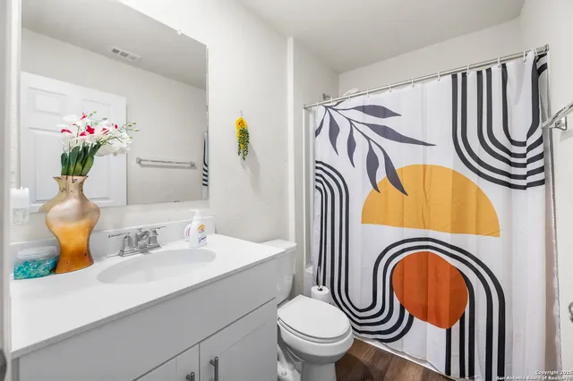 a bathroom with a sink a mirror a toilet and a mirror