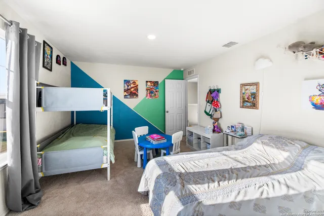 a bedroom with a bed and dresser