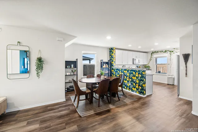 a dining room with furniture and wooden floor