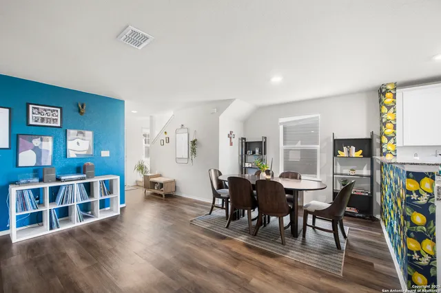 a view of a dining room with furniture and chandelier