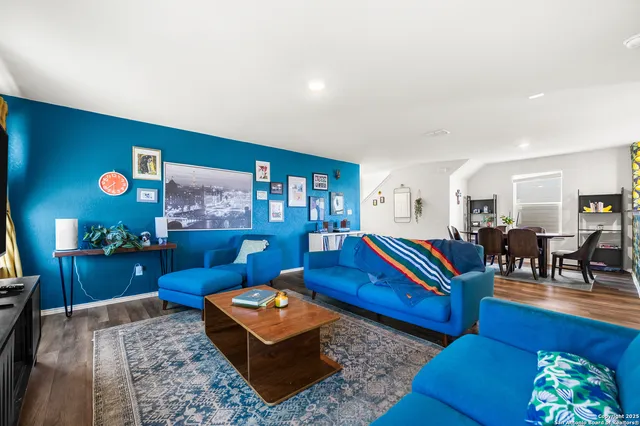 a living room with furniture and wooden floor
