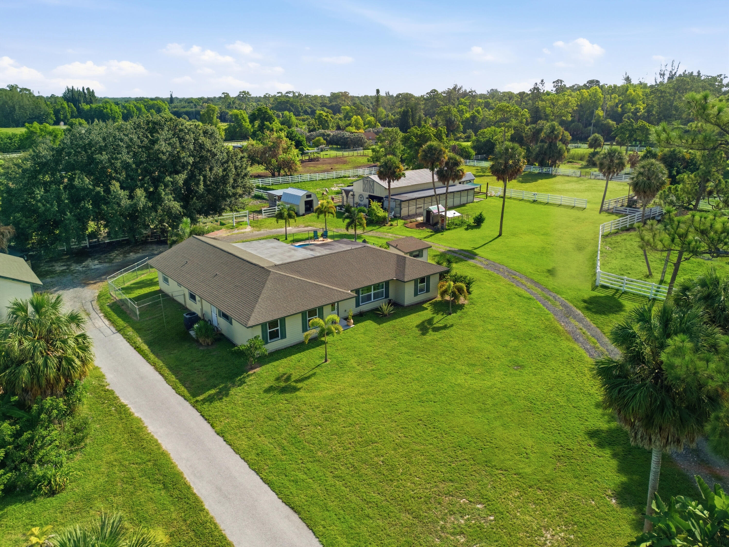 14095 Biddex Road Loxahatchee Groves, FL 33470 - Photo 61 of 69 a aerial view of a house with swimming pool outdoor seating and yard