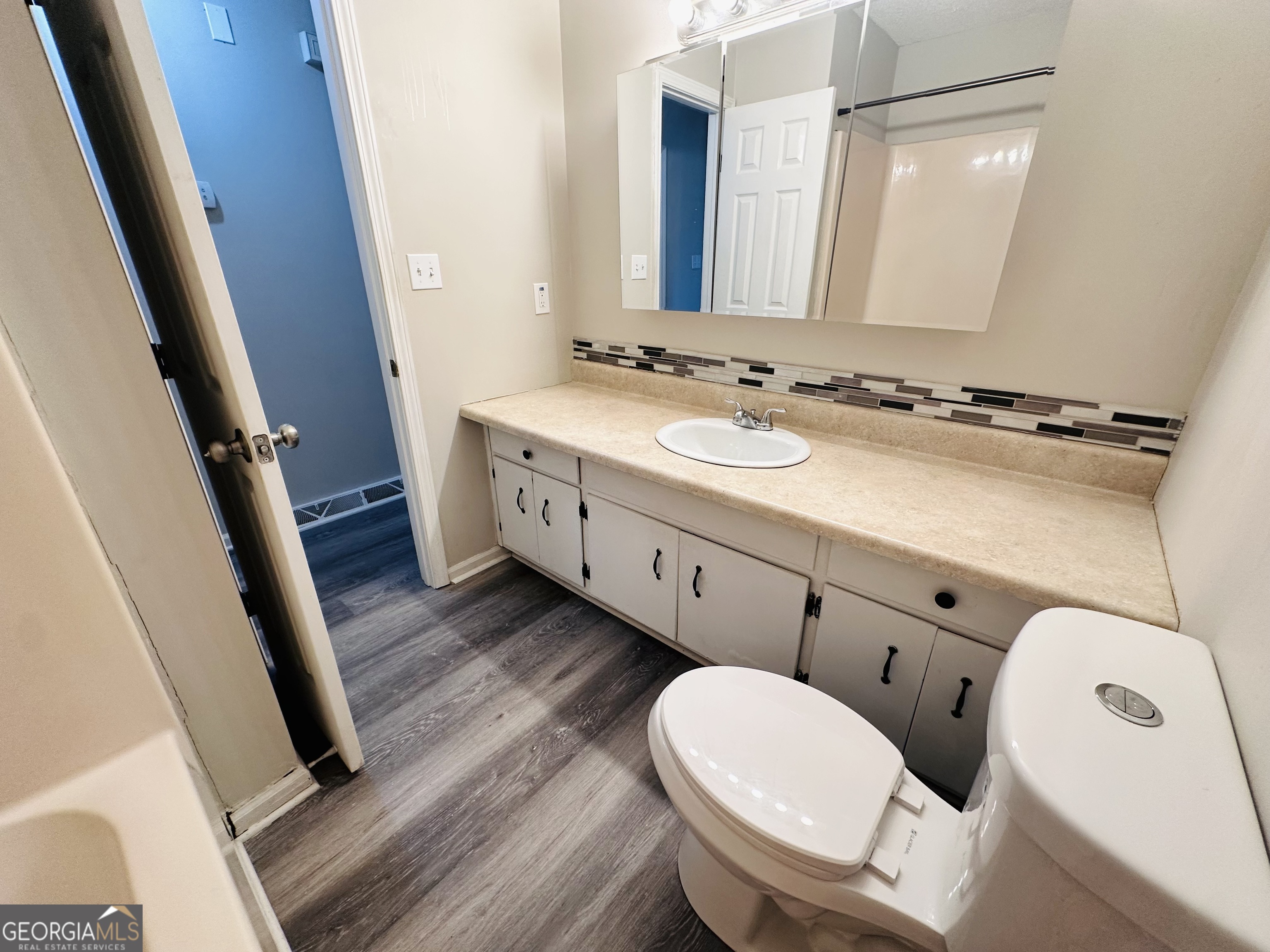 514 South Broad Street Toccoa, GA 30577 - Photo 11 of 22 a bathroom with a double vanity sink and mirror