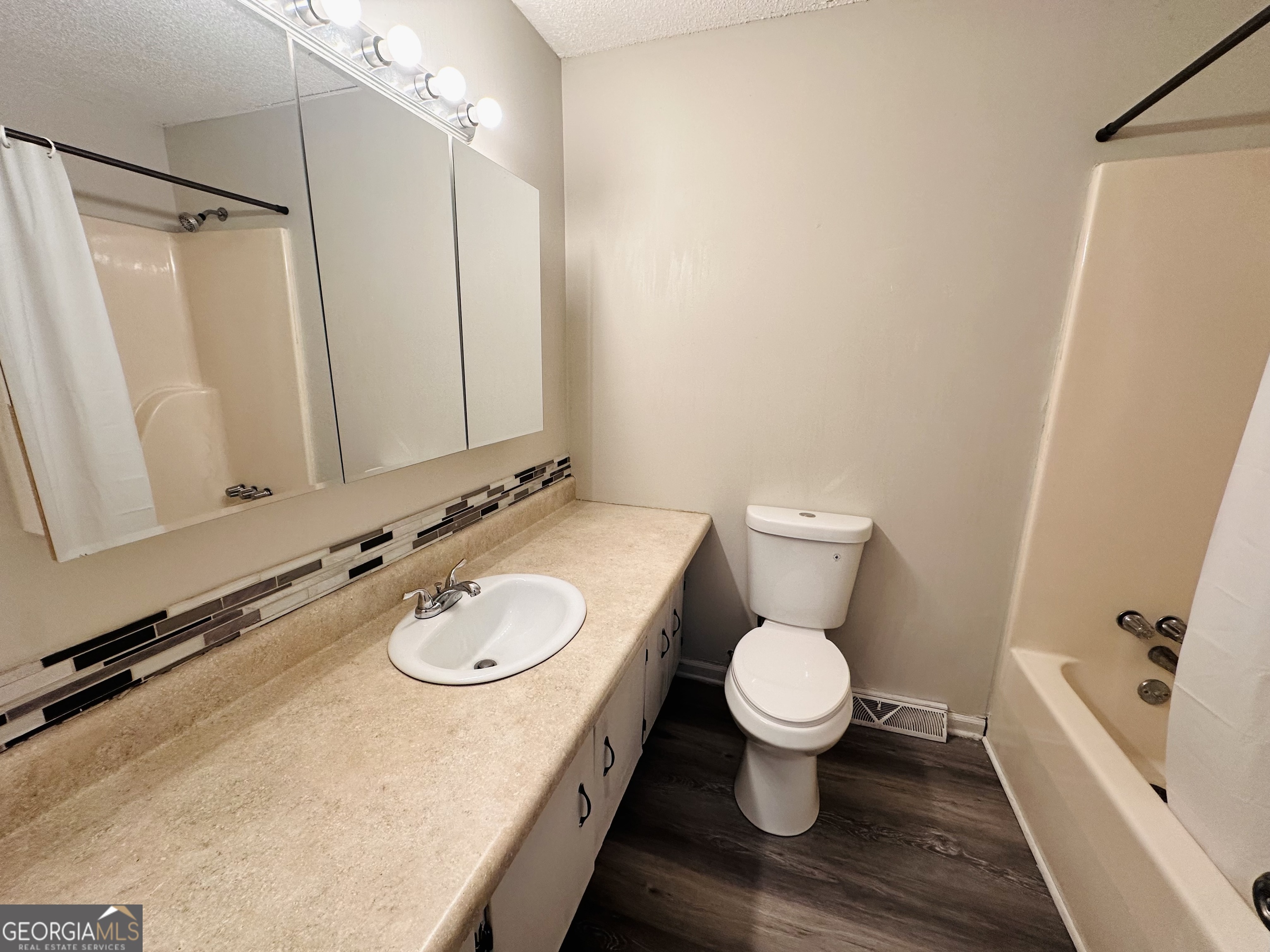 514 South Broad Street Toccoa, GA 30577 - Photo 12 of 22 a bathroom with a granite countertop sink toilet and shower