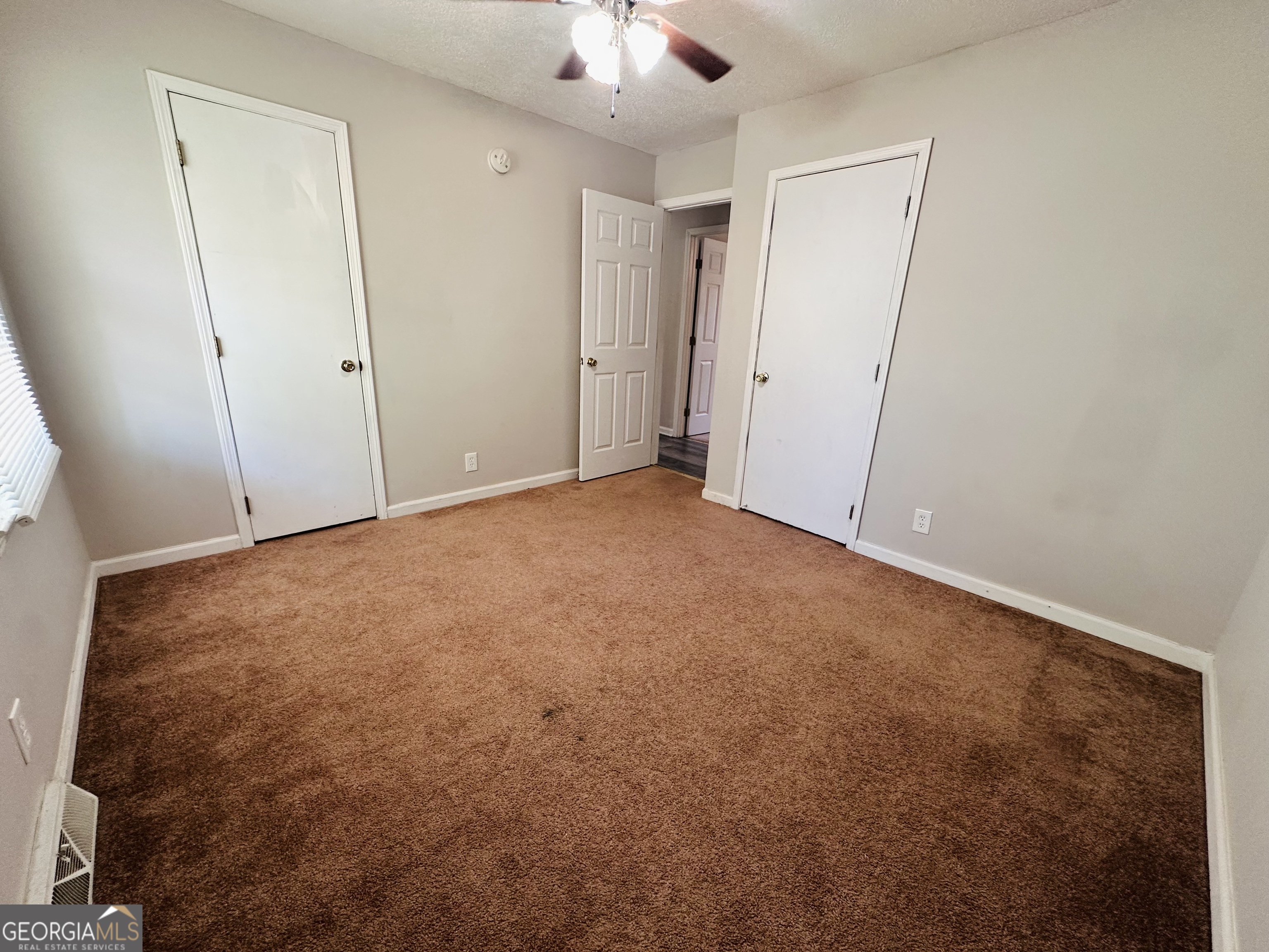 514 South Broad Street Toccoa, GA 30577 - Photo 14 of 22 an empty room with a ceiling fan