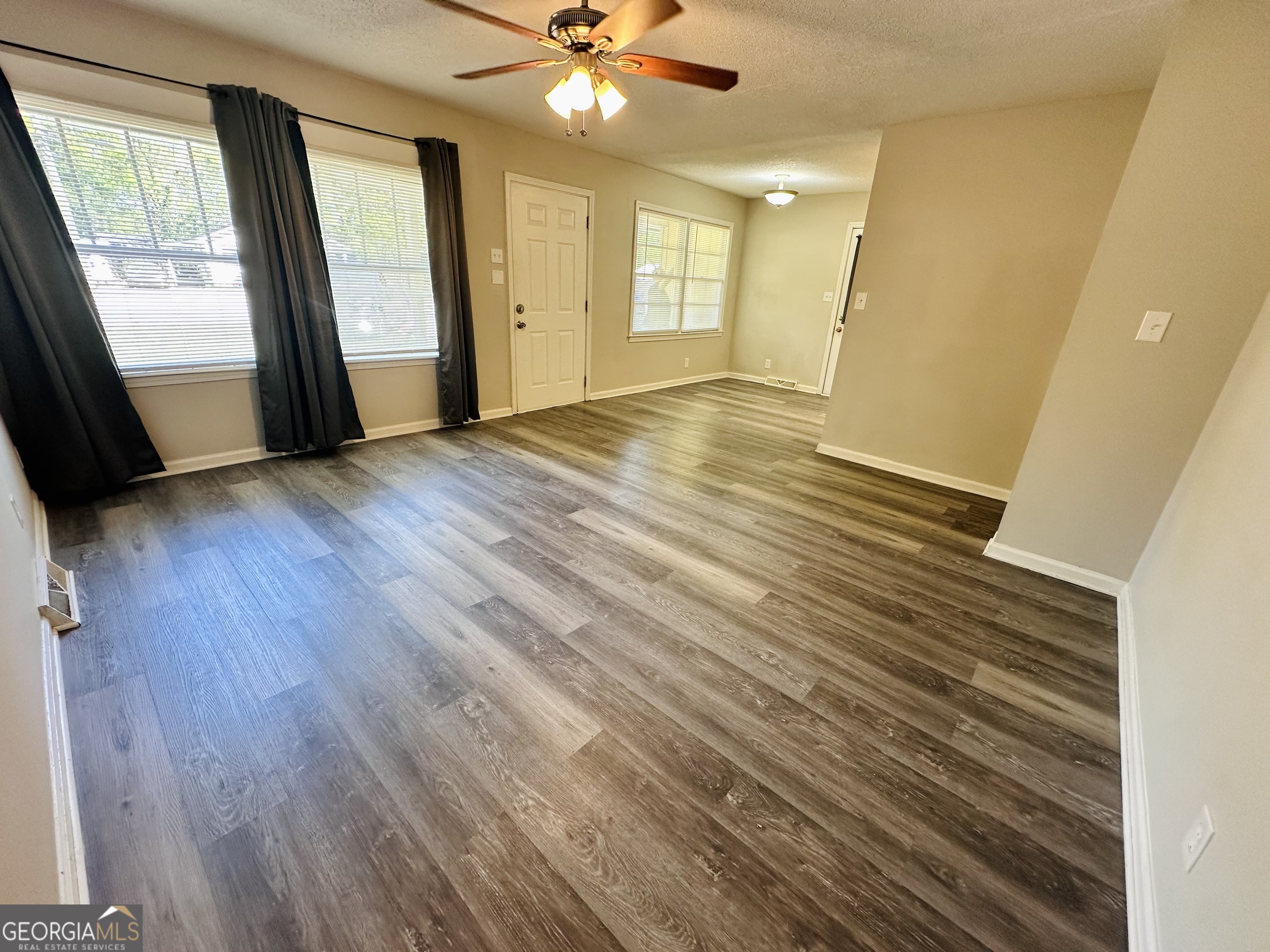 514 South Broad Street Toccoa, GA 30577 - Photo 5 of 22 wooden floor in an empty room with a window