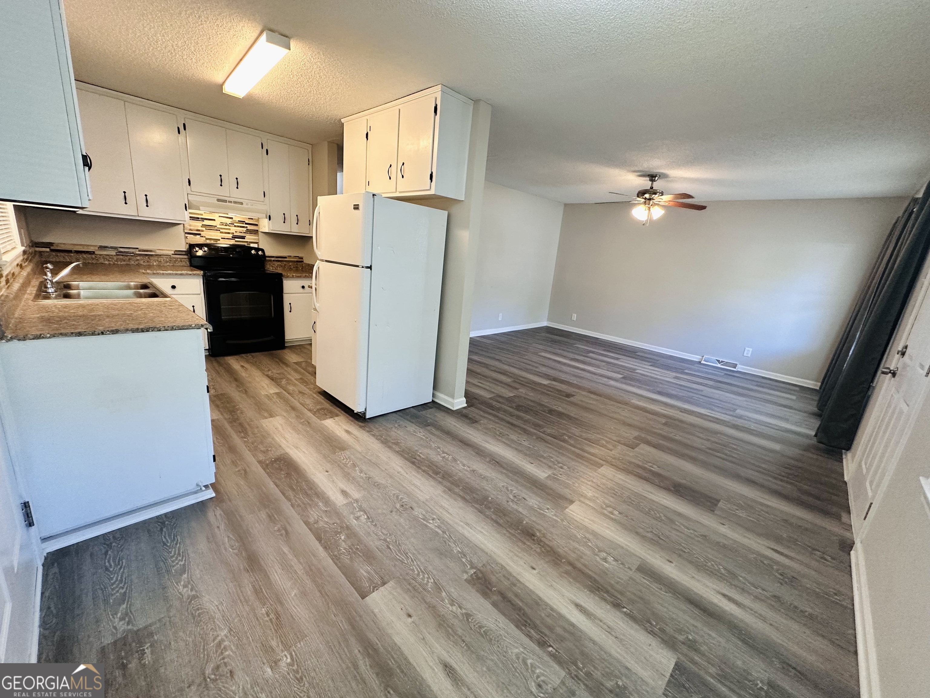 514 South Broad Street Toccoa, GA 30577 - Photo 6 of 22 a kitchen with stainless steel appliances granite countertop a refrigerator a stove top oven a sink and dishwasher