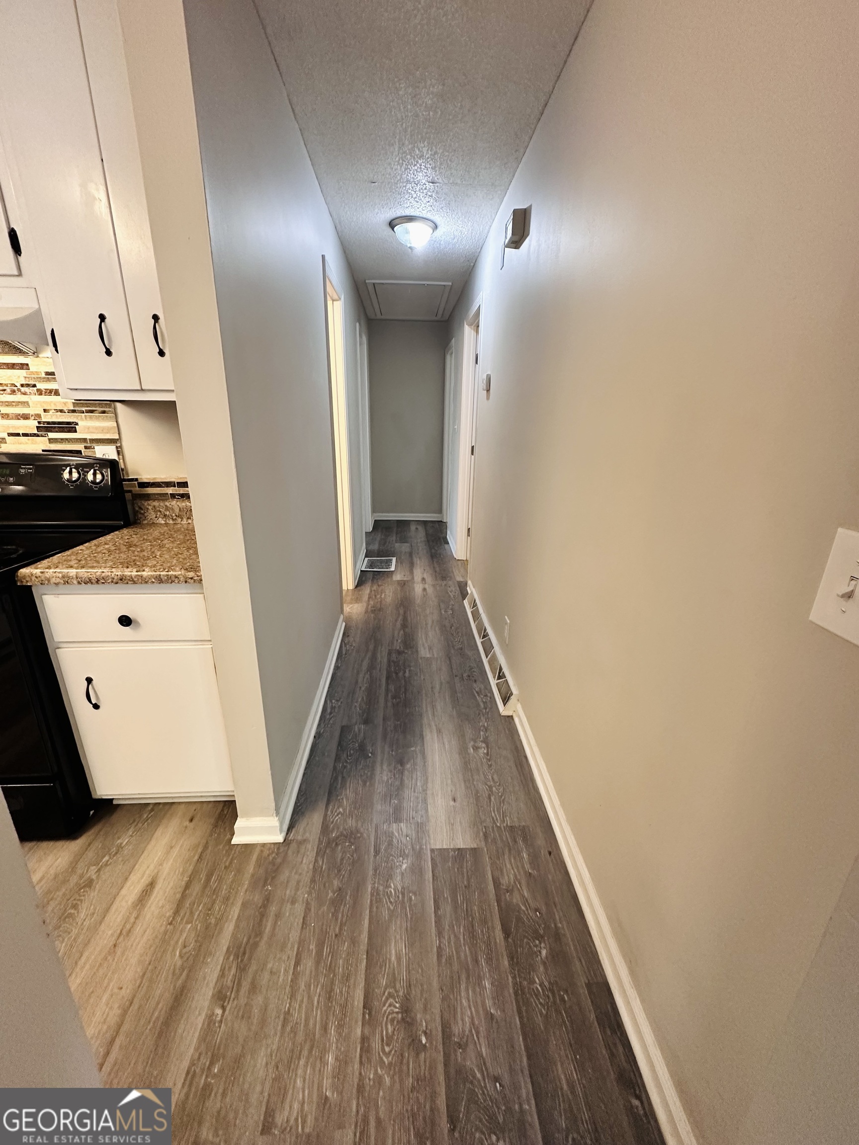 514 South Broad Street Toccoa, GA 30577 - Photo 10 of 22 a view of a hallway with wooden floor