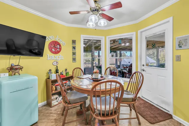 a dining room with furniture and a flat screen tv