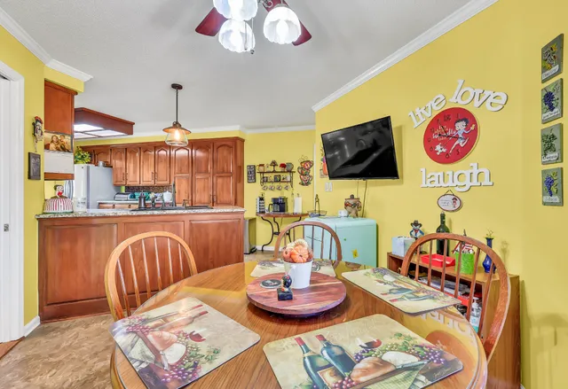 a utility room with dryer washer and a view of living room