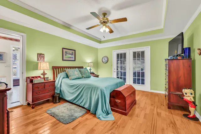 a bedroom with a bed and a flat screen tv