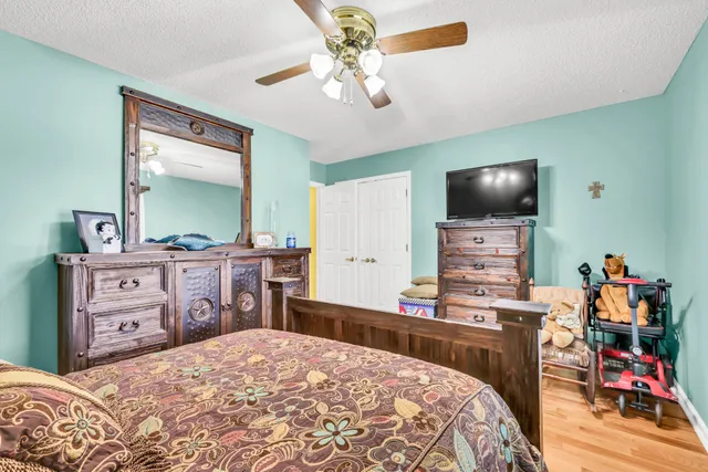 a view of a dining room with furniture and a chandelier fan