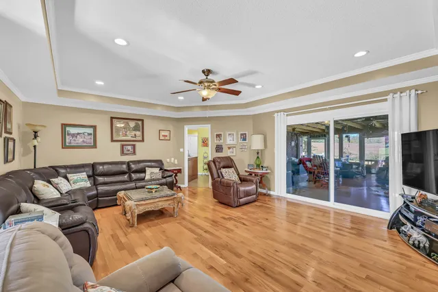 a living room with furniture and a wooden floor