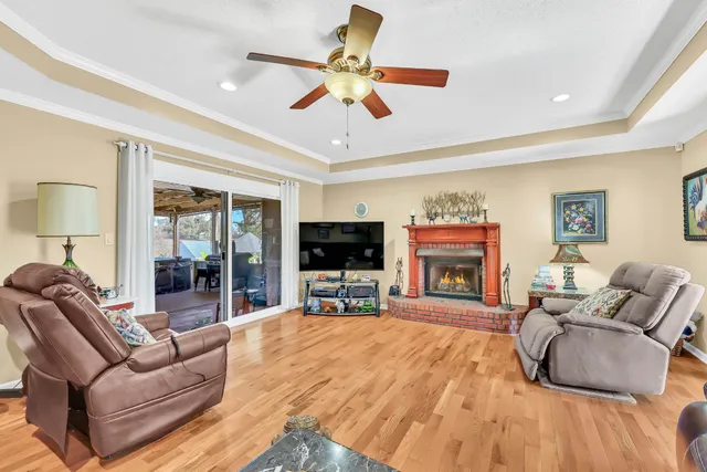 a living room with fireplace furniture and a flat screen tv