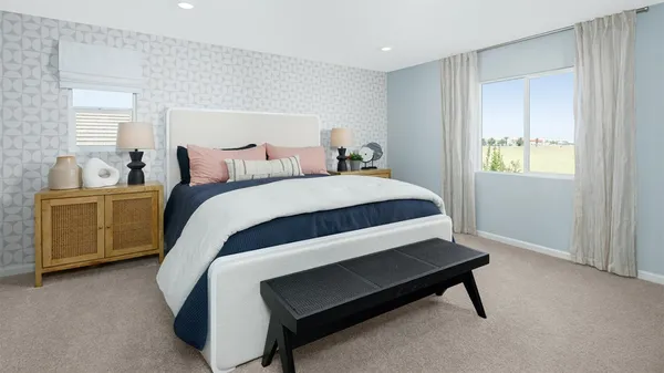 a bed sitting in a bedroom next to a window