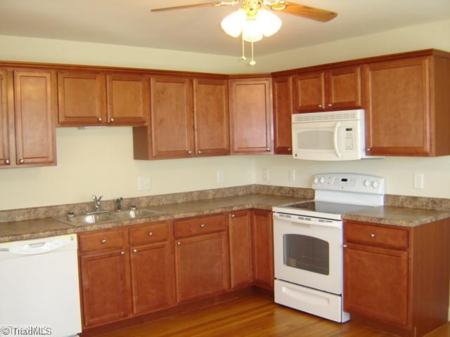 1002 Gideon Grove Road Stokesdale, NC 27357 - Photo 6 of 12 Kitchen. New cabinets, appliances and countertops with lots of room