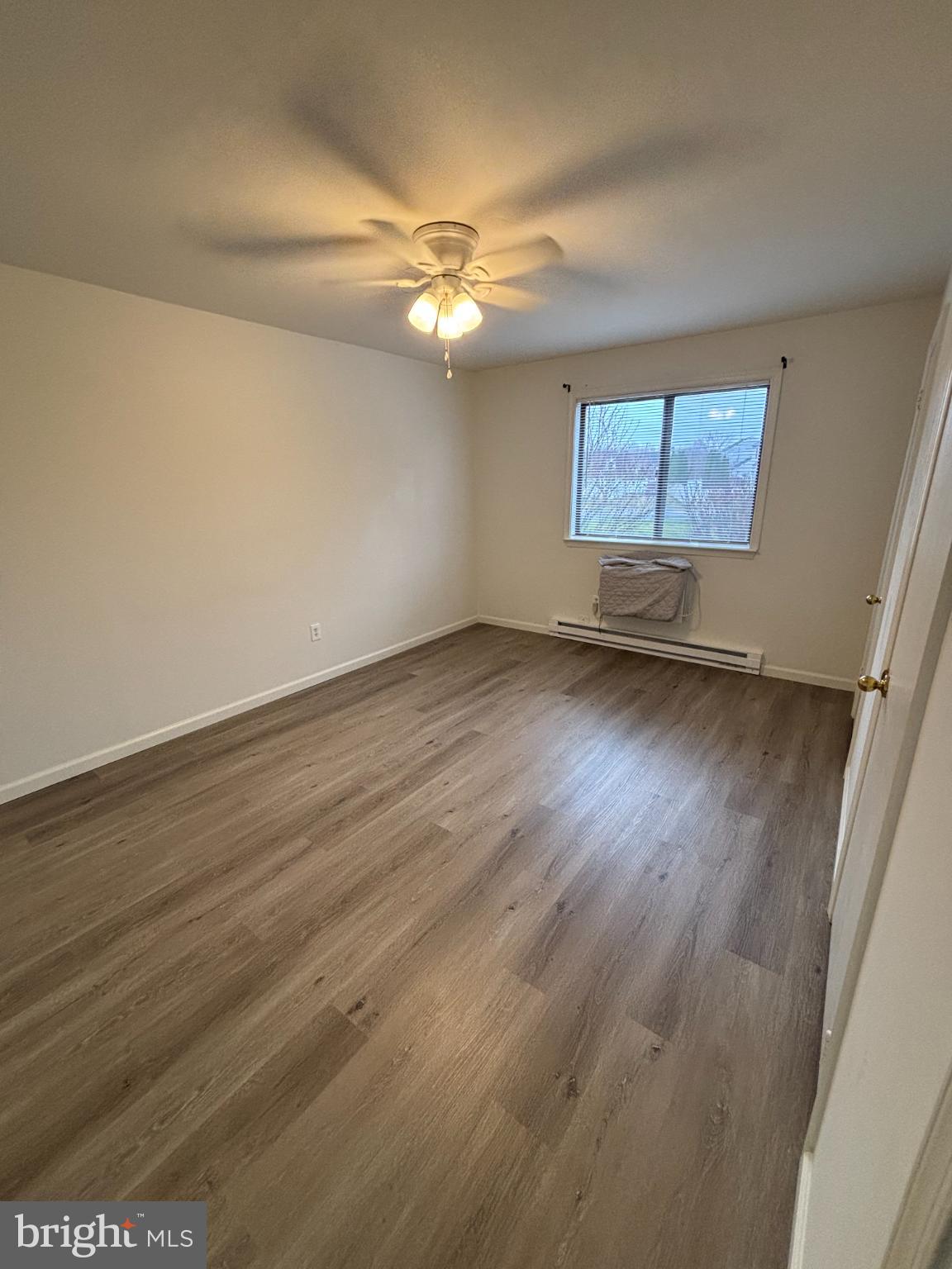 612 North Shady Retreat Road, Unit 55 Doylestown, PA 18901 - Photo 11 of 23 an empty room with wooden floor fan and windows
