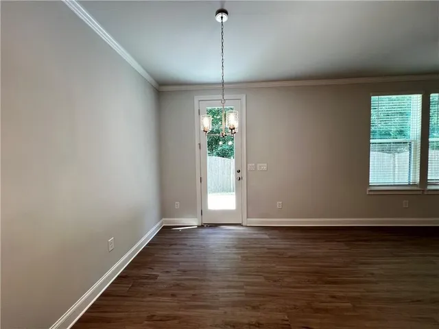 a view of room with window and wooden floor